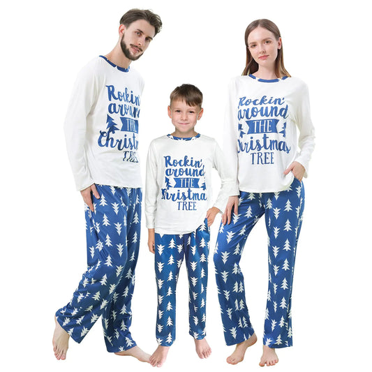 Family wearing matching Christmas pajamas with blue and white designs.